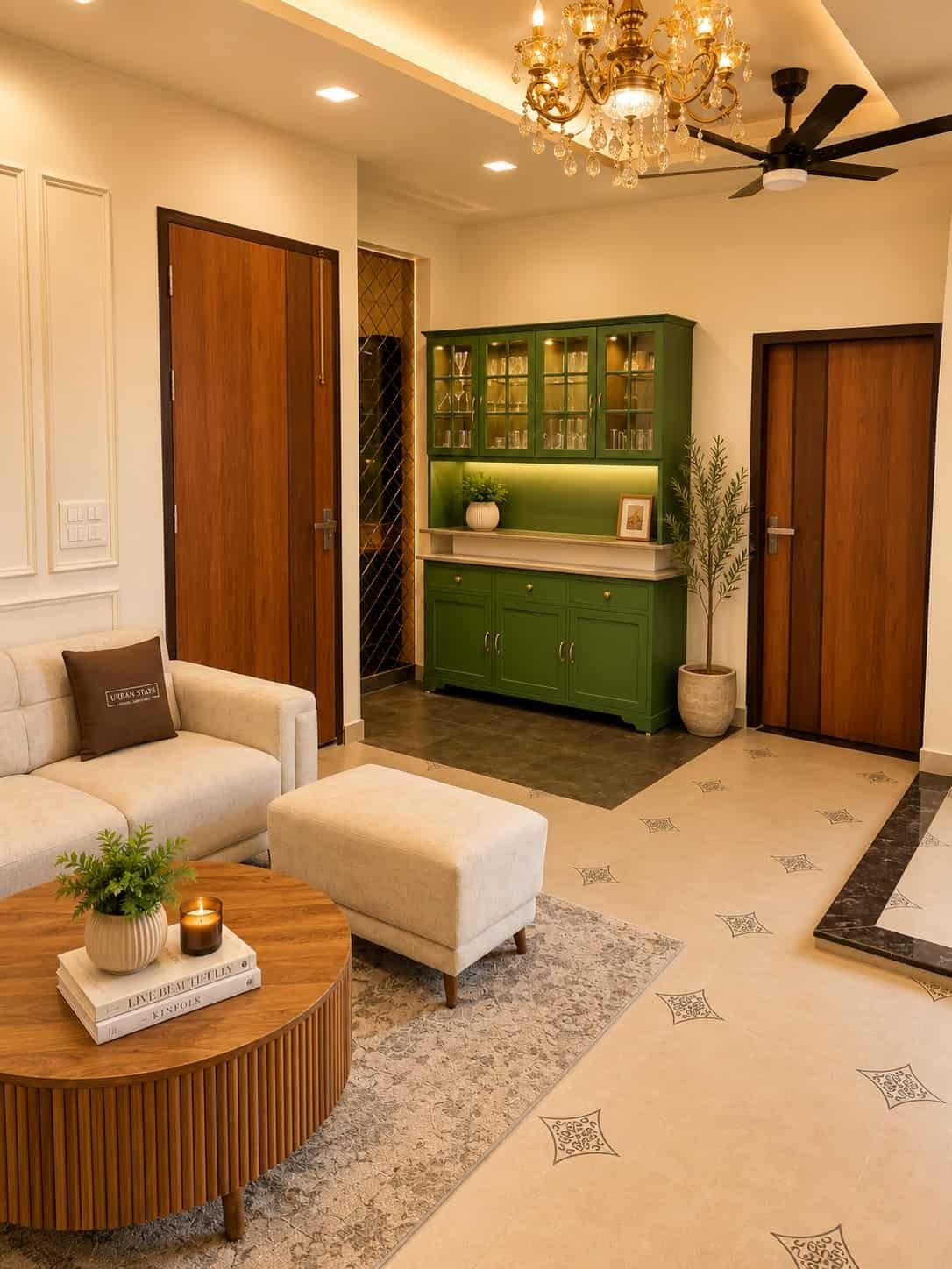 Living room with a white sofa, round wooden coffee table and green display cabinet under a chandelier