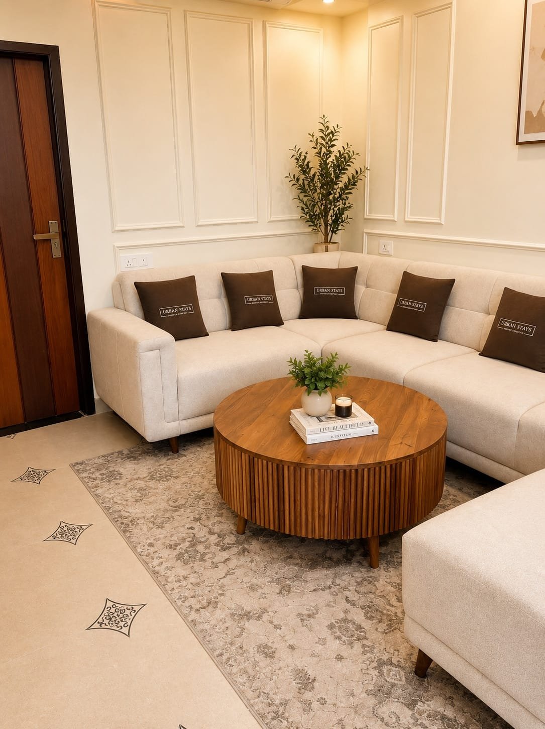 White sectional sofa with brown cushions around a round wooden coffee table