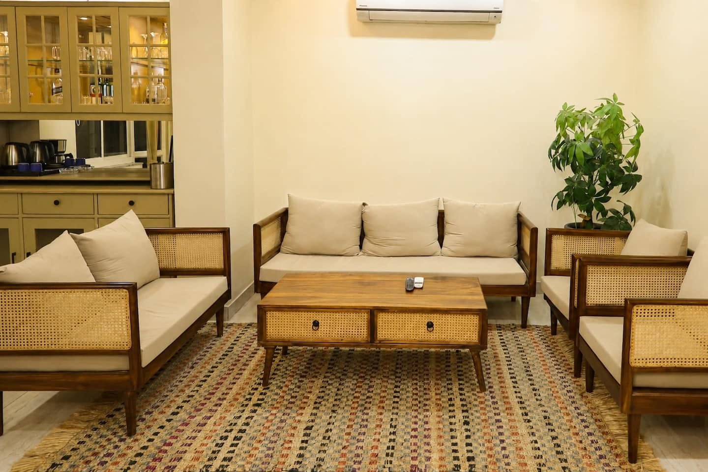 Cane sofas with cream cushions arranged around a low wooden table
