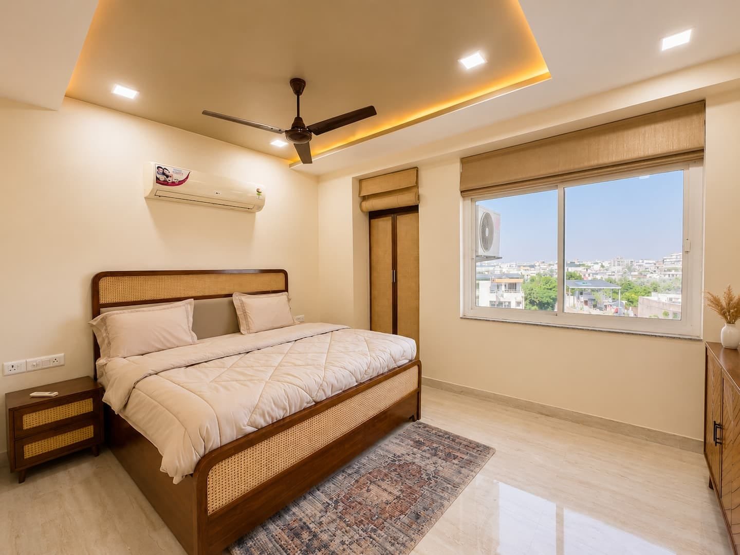Bedroom 1 with a cane-headboard king bed and a window over the city