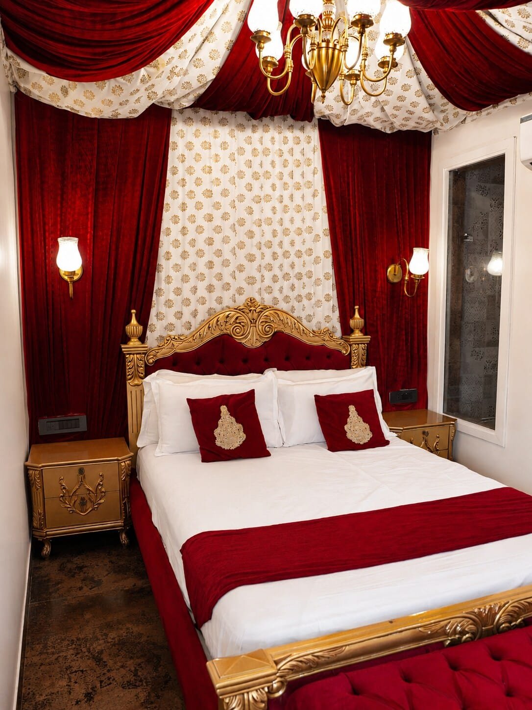 Bedroom 3 with a red-and-gold bed beneath a canopy of drapes
