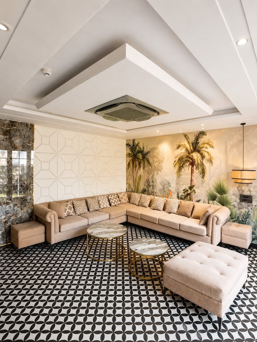 Living room with a beige sectional, tropical mural and black-and-white patterned floor