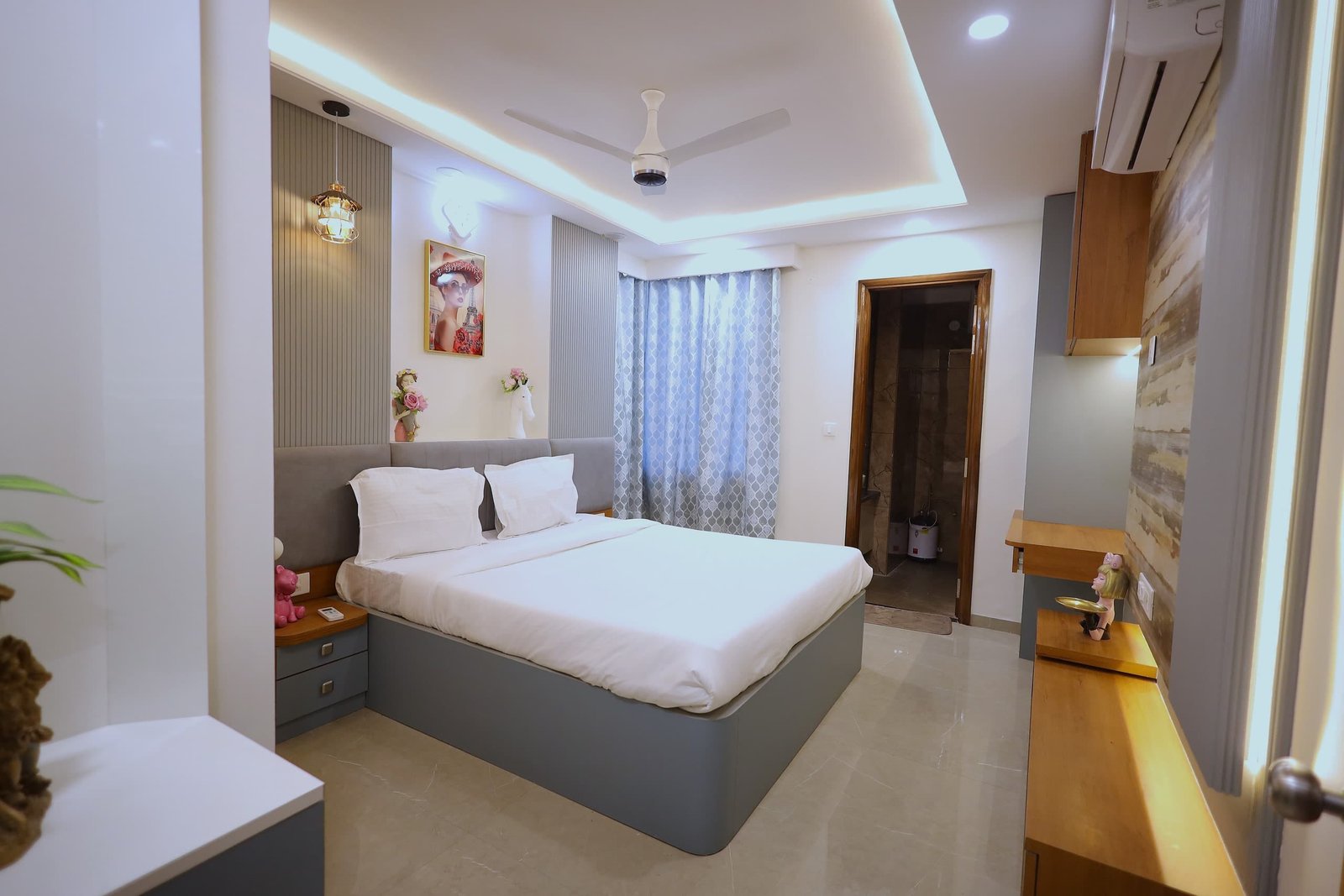 Bedroom 2 with a white double bed, wooden side tables and a ceiling fan