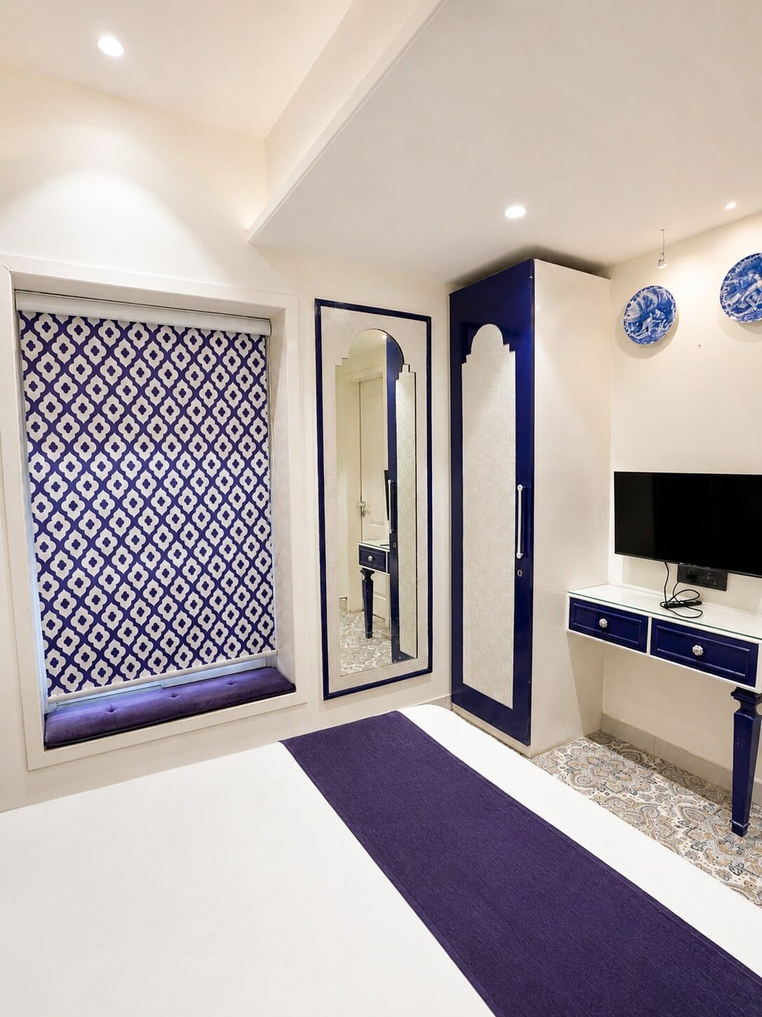 Bedroom 2 with a mirrored wardrobe, desk and TV