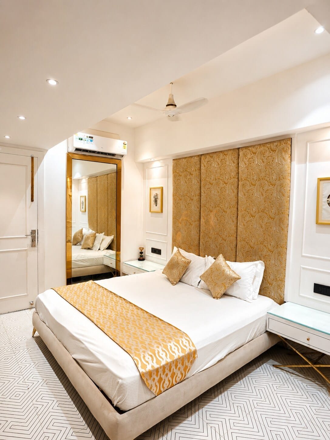Bedroom 3 with a gold-patterned headboard panel and full-length mirror
