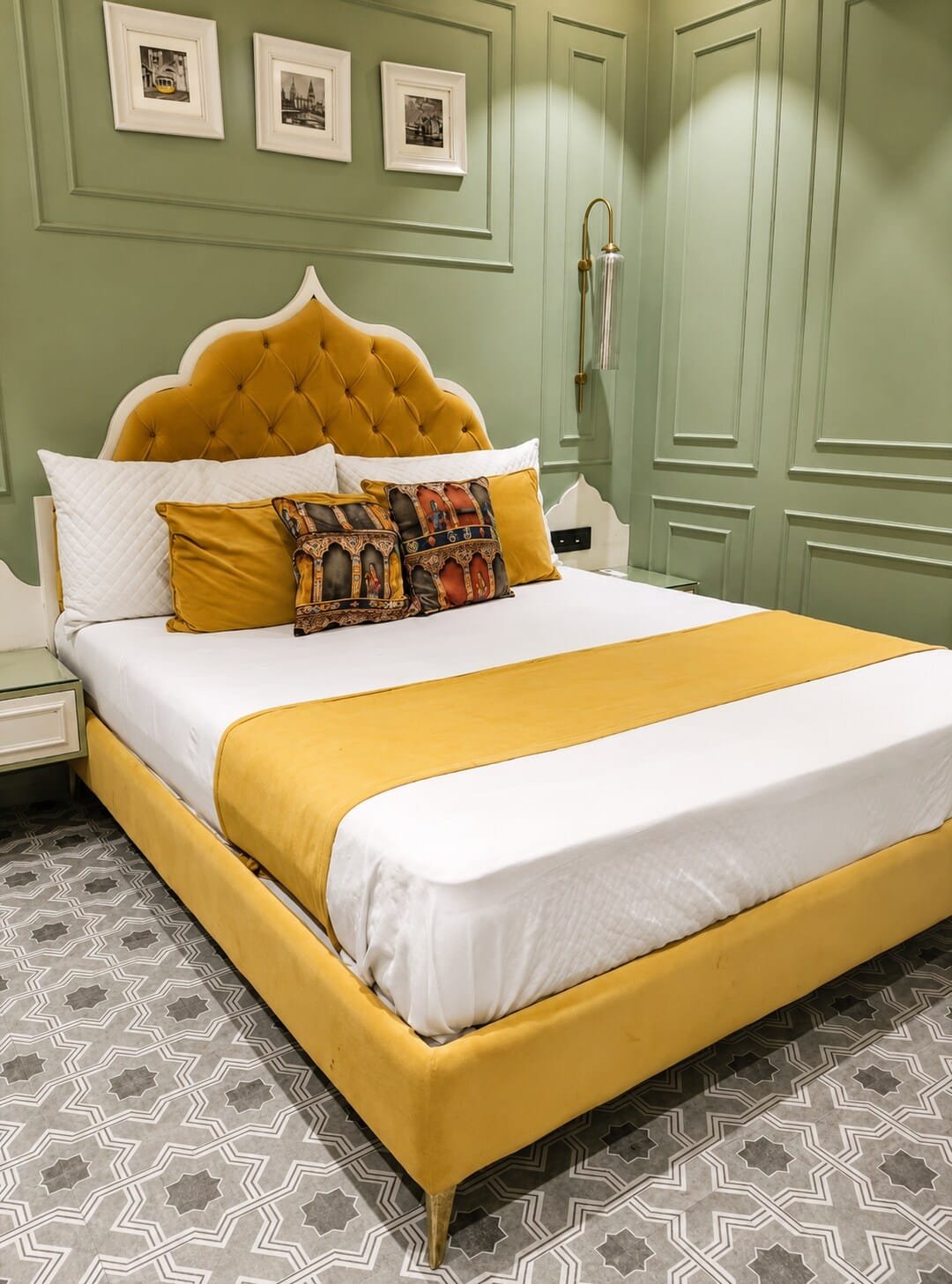 Bedroom with sage panelled walls and a mustard scalloped headboard