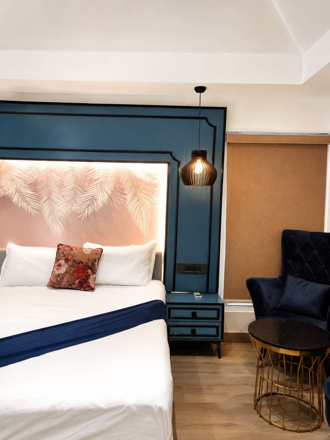 Bedroom 2 with a navy panelled wall and a pink backlit headboard