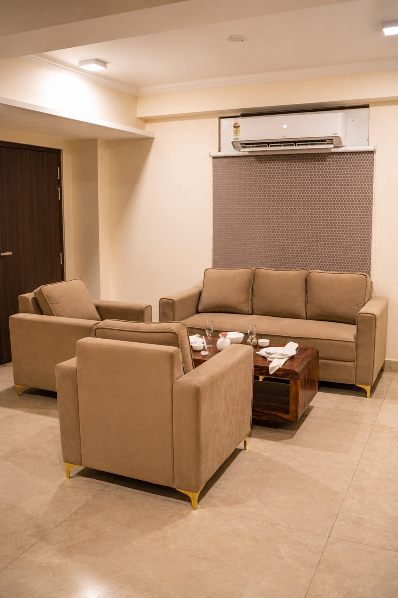 Sitting area with a beige sofa, two armchairs and a low table