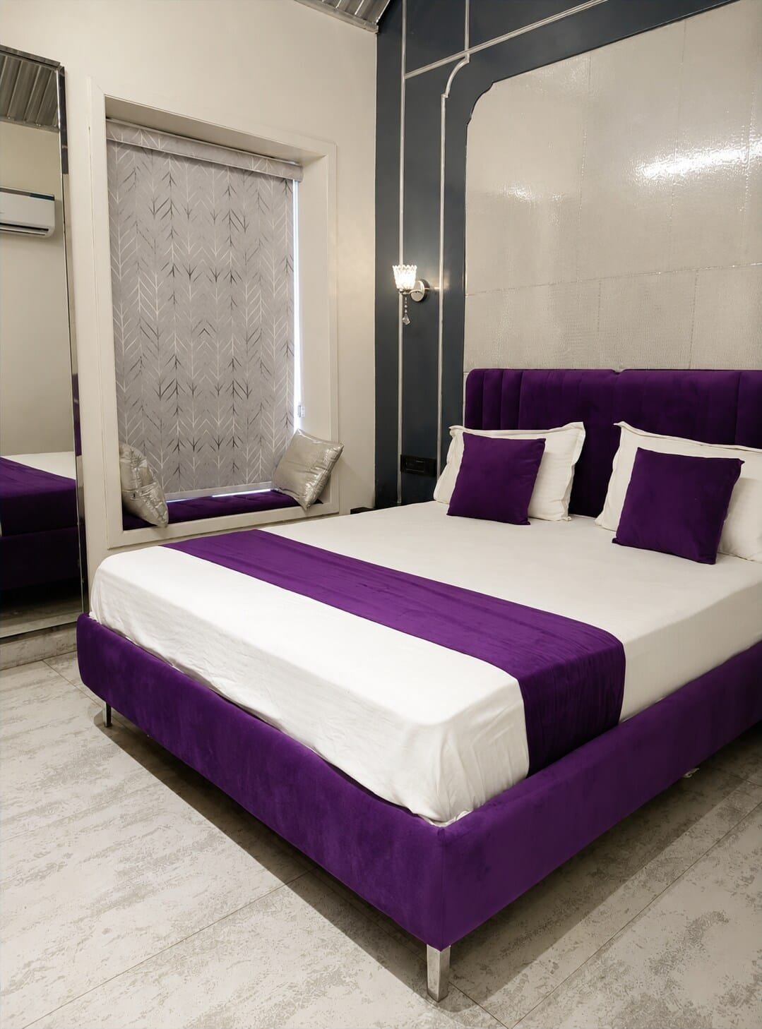 Bedroom 4 with a purple-trimmed bed and a navy feature wall