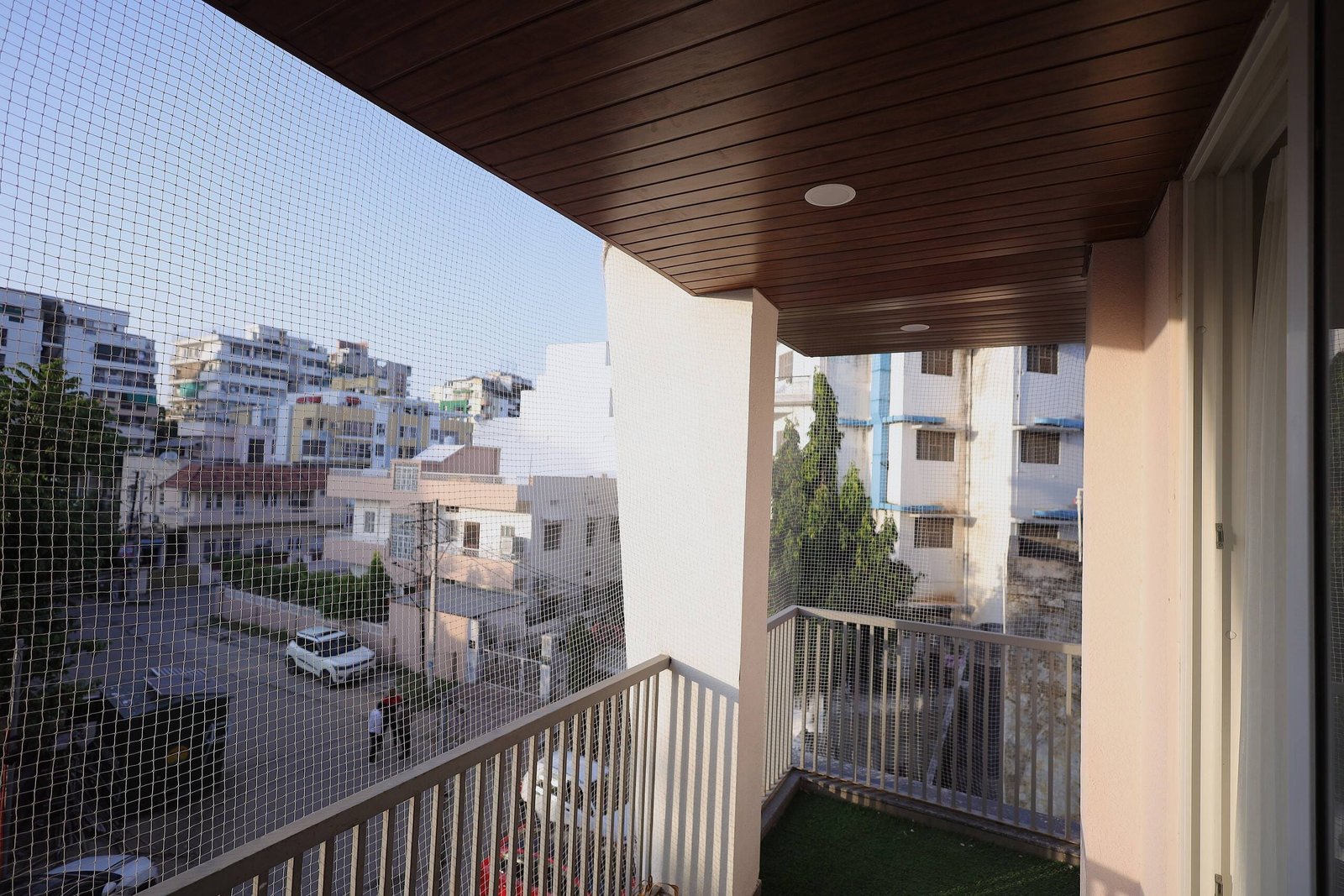 View over the neighbourhood from a balcony under a wooden ceiling