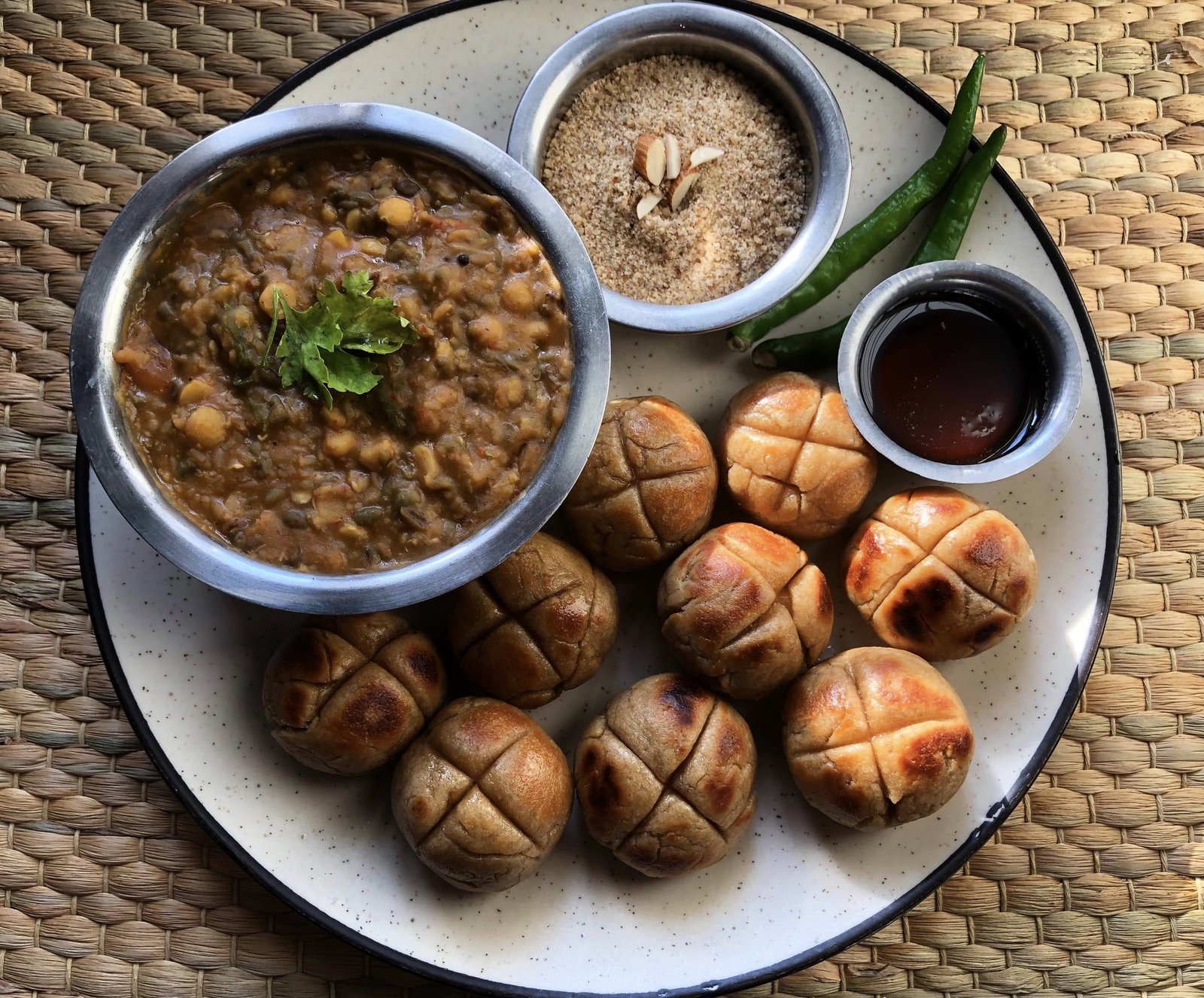 Dal baati churma: baked wheat balls around a bowl of dal