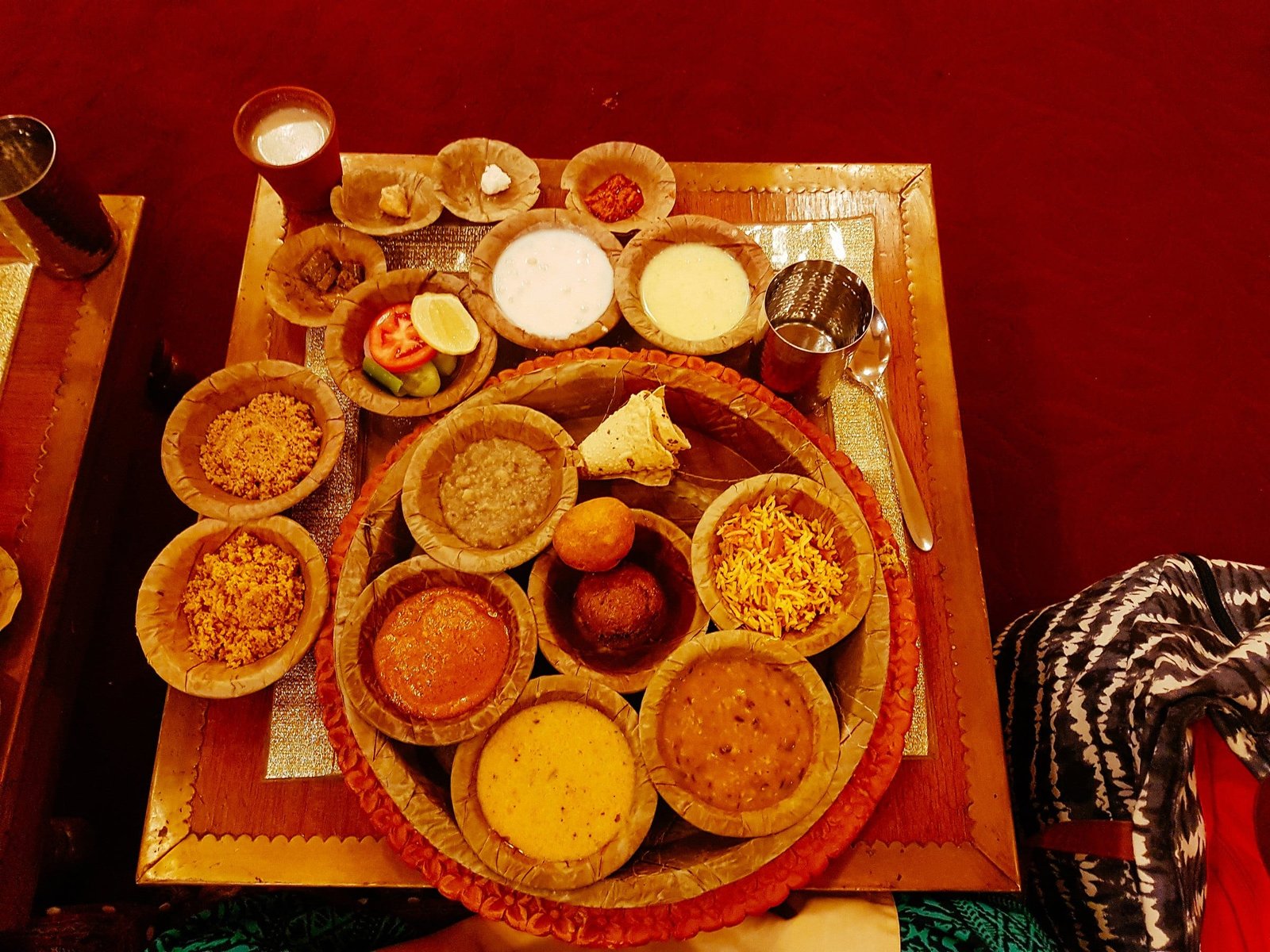 A Rajasthani thali of small bowls on a brass plate