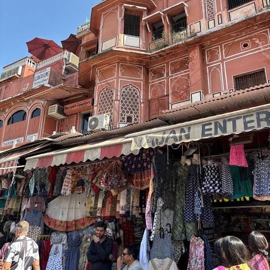 A clothes shop under a pink building in Tripolia Bazaar